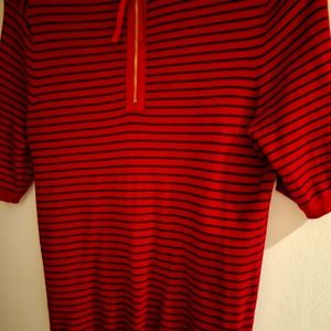 Red and blue sweater with gold zipper in back